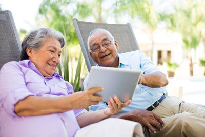 Smiling elderly couple looking at tablet computer